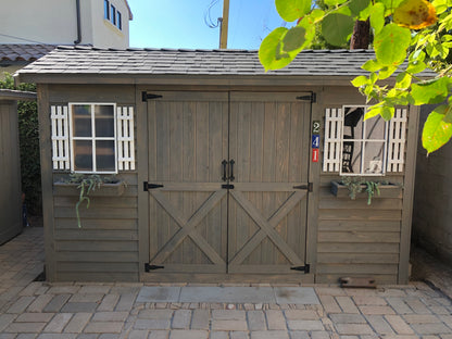 stained cedar wood longhouse shed with window boxes and shutters