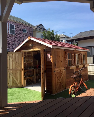 bike shed with double doors windows and window boxes